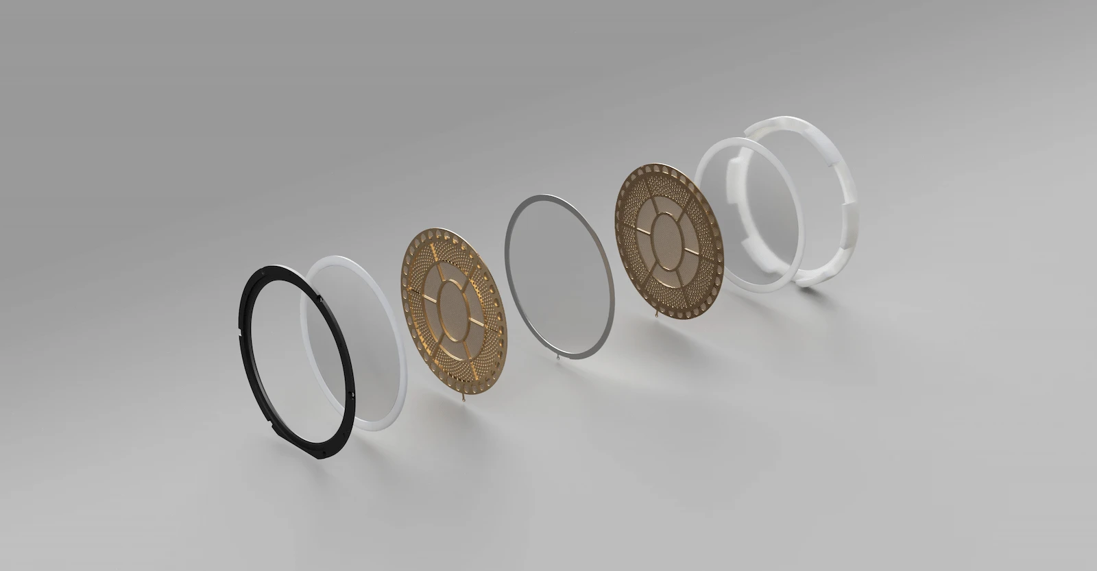 STAX社の静電型ヘッドホンの内部構造。分解された各パーツ（振動板、電極、防湿膜）が並んで展示されており、静電型ヘッドホンの精密な技術が理解できる